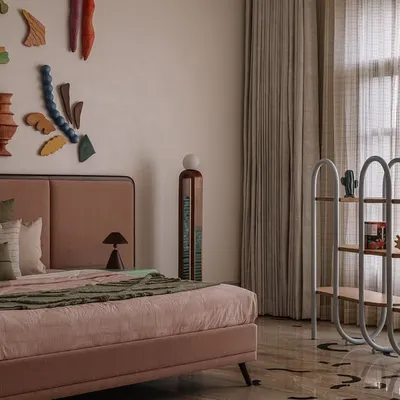 The showstopper of this bedroom is the 'Love is a Wave' wall installation, a collaboration with a talented artist. The collection of handcrafted ceramic pieces evokes the serenity of the ocean, turning the wall behind the bed into a captivating art piece.