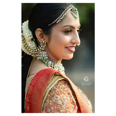 A profile view of Likitha's regal wedding look. This showcases the importance of creating a balanced side profile, ensuring the hair, jewelry, and makeup work in perfect harmony.