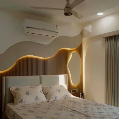 A master bedroom where organic, flowing lines on the wall create a sense of calm. The backlighting and fluted wood paneling add warmth and texture, making this a truly serene retreat.