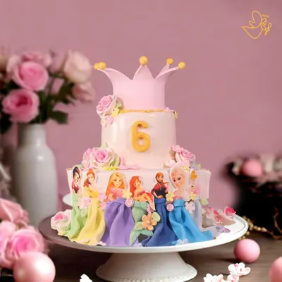 This two-tier Disney Princess cake is a fairytale dream come true, featuring beloved princesses like Elsa and Rapunzel, all handcrafted with fondant and topped with a royal crown for a magical 6th birthday.