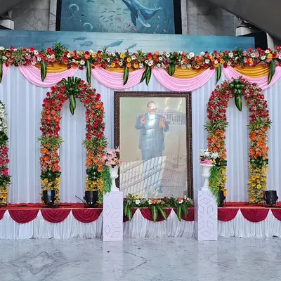 This is the full view of a stage I designed for a formal tribute at ONGC. The symmetrical design with four floral arches and a clean, draped backdrop ensures a professional and dignified look suitable for any corporate or government event.