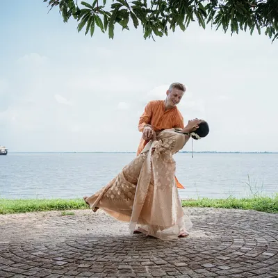 A romantic dip against the serene backwaters of Kerala, showcasing a beautiful destination wedding. I plan weddings not just in Bangalore, but also in stunning locales like Coorg, Mysore, and Kerala.