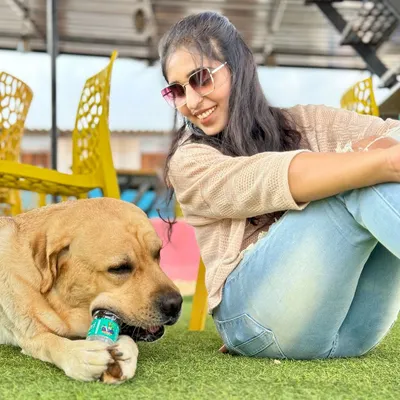 Just a girl and her best friend, chilling on the lawn. This is the relaxed, happy vibe we strive for every day.