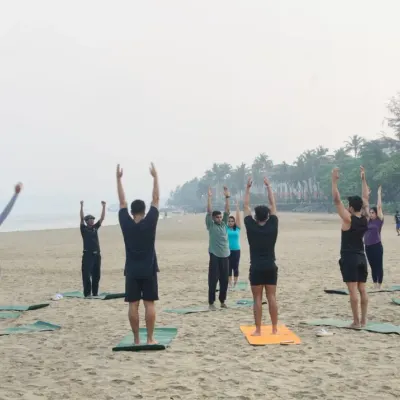 A sunrise yoga session begins with greeting the sun. Here, my group class is performing Urdhva Hastasana, a simple upward salute that stretches the spine and opens the body, setting the tone for the practice ahead.