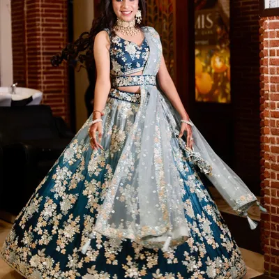 A client looking absolutely radiant in a deep teal and silver floral embroidered lehenga. This is a stunning choice for an engagement or sangeet.