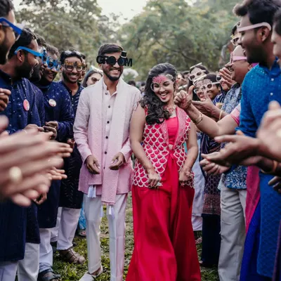 The grand entrance! Capturing the couple's joyful arrival at their Haldi party, surrounded by friends and family.