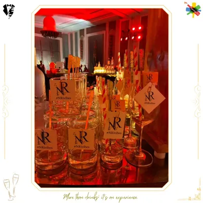 Custom glassware for an event, featuring tags with the personalized hashtag #NRvibes. This is a simple yet effective way to brand an event.