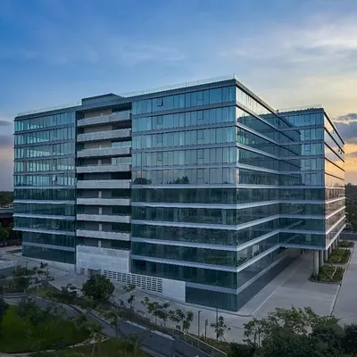 An aerial view of the Godrej Centre Development, showcasing its significant scale and the strategic massing of its glass-clad volumes. The design integrates rejuvenating balconies and green buffers to soften the building's presence in the urban landscape.