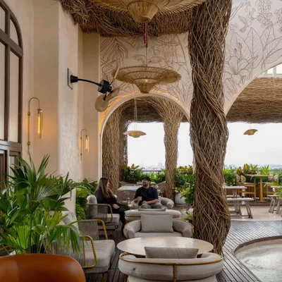 Another view of the Nido rooftop bar, showcasing the interplay between the handwoven lantana ceiling and the open sky. We designed this space to feel like a natural escape, with comfortable lounge seating perfect for conversations.