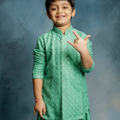 Rock on. This little star is all smiles in our mint green Patiala set. This collection blends timeless tradition with playful charm, perfect for lighting up any room.