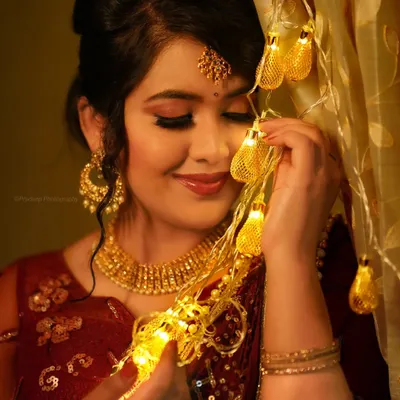 A festive portrait for a makeup artist collaboration. The warm fairy lights add a magical glow, highlighting the beautiful makeup and jewelry.