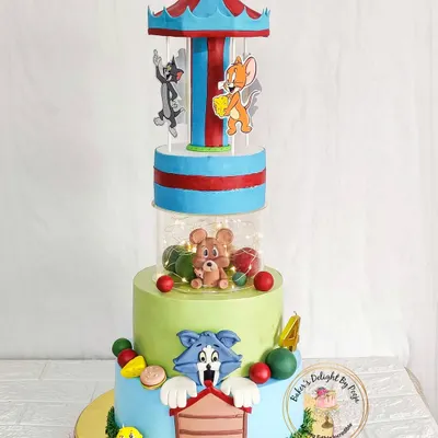 A truly special creation, this Tom & Jerry cake features a rotating carousel with lights. This multi-tiered design brings the classic cartoon to life with playful scenes and characters, making it a showstopper for a memorable birthday.