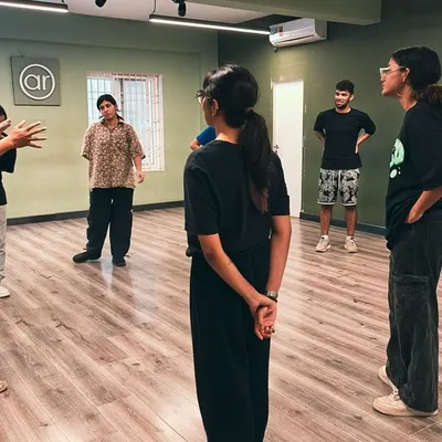 A typical moment in one of our classes. An instructor breaks down a move for a small group of students, ensuring everyone understands and feels comfortable. This is a safe space to learn and grow.