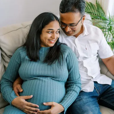 A happy, candid moment shared on the sofa. Home sessions allow for this kind of relaxed intimacy, where you can just be yourselves while I capture the connection between you.