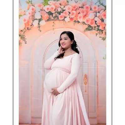 A radiant solo portrait in front of our dreamy floral arch. The mom-to-be looks beautiful in a light pink gown that perfectly matches the soft tones of the flowers. This is a classic and elegant maternity shot.