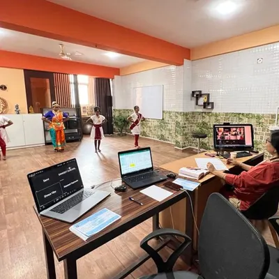 A view of our hybrid classroom where students are present both physically and virtually. Our technology setup allows for seamless interaction between the guru and all students, regardless of their location.