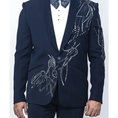This is not your average tuxedo. A deep navy jacket with stunning silver abstract embroidery on the shoulder and body, paired with a matching embellished bow tie. It's a wearable piece of art for any formal event.