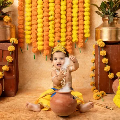 The classic 'Makhan Chor' moment. We use safe, dry ice to create a magical smoke effect from the butter pot, resulting in a playful and divine portrait.