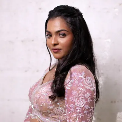 The art of subtle glam for a reception. This look features soft, flowing hair and makeup that enhances her natural beauty without being overpowering. The focus is on radiant skin and defined eyes.