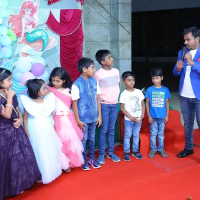 Getting a group of young guests on stage to help with a trick at a mermaid themed birthday party. Audience participation is a key part of every kids' show I do.