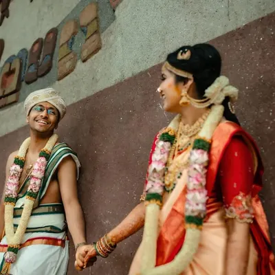 A candid moment of a newly married couple sharing a smile. We love capturing these quiet, happy interactions right after the main wedding rituals are complete.