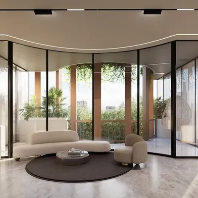 A rendering of the Amara Avika luxury residences in Chennai. The design features a curved glass facade that separates public and private zones, creating a transparent and seamless connection with the leafy Poes Garden neighborhood.