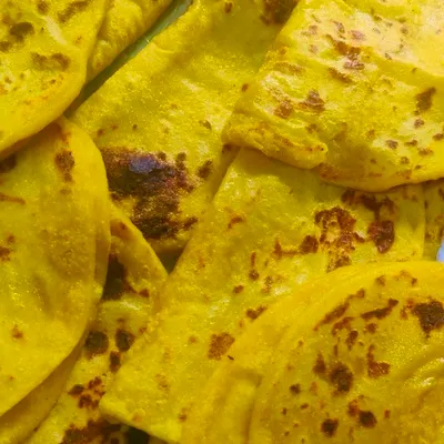 A pile of freshly made Holige, also known as Obbattu. This traditional sweet flatbread, stuffed with a lentil and jaggery filling, is a festive delicacy in Karnataka.