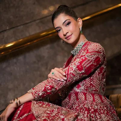 A beautiful portrait showcasing a soft glam look on my muse Hanna. The makeup features a clean, elegant updo and a defined eye, perfect for complementing her red Jayanti Reddy outfit.