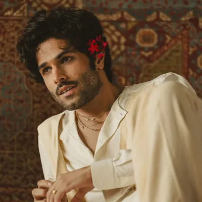 A collaboration where music, acting, and fashion merge. This layered white ensemble, crafted by us, was designed for a poetic visual reimagining of a timeless ghazal.