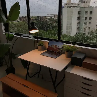 A view of my workspace on a rainy day. My desk is where I do all of my digital work, with my laptop and drawing tablet ready to go.