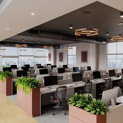 A wide view of a completed office in Pune, where we integrated the brand's red and grey colors into the design. The space combines open workstations with planters that act as natural dividers, promoting a collaborative yet organized atmosphere.