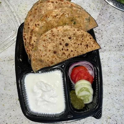 A simple and satisfying meal of hot, layered parathas served with cool dahi and a side of fresh salad. This is a classic North Indian comfort food option, perfect for lunch or dinner.