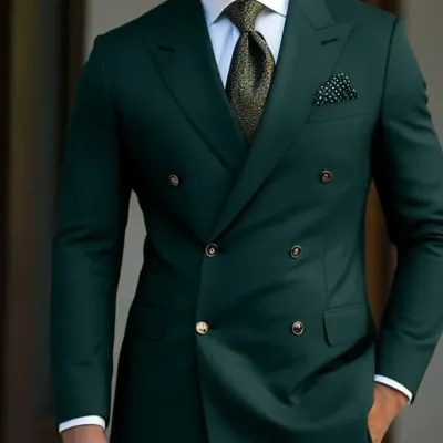 A classic double-breasted suit in a deep forest green. The peak lapels and sharp tailoring create a powerful and sophisticated silhouette. This is a timeless piece for any gentleman's wardrobe.