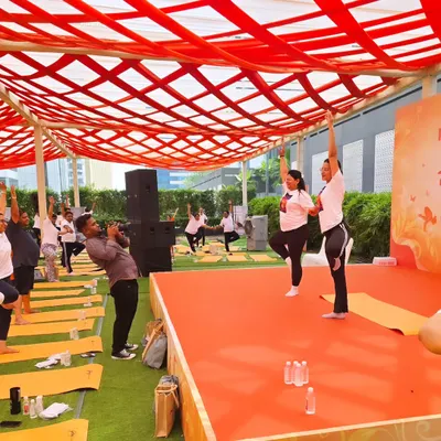 Leading a session on stage during a corporate wellness event. I enjoy guiding large groups and making yoga accessible and enjoyable for everyone, regardless of their experience level.