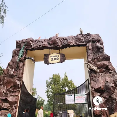 A full view of the Rohtak Zoo entrance gate we constructed. The design incorporates various animal sculptures, such as a crocodile and antelope, directly into the rock-like structure.