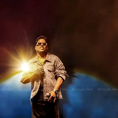A powerful hero shot of musician Yuvan Shankar Raja, illuminated by a single starburst of light against a smoky backdrop. This image showcases our ability to create dramatic and iconic concert photos.
