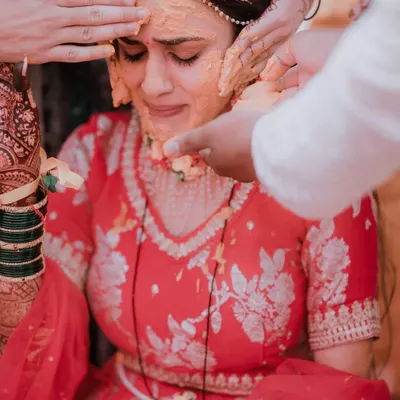 An emotional and powerful moment as the bride is moved to tears while receiving blessings and haldi from her loved ones. These are the raw, real moments I strive to capture.