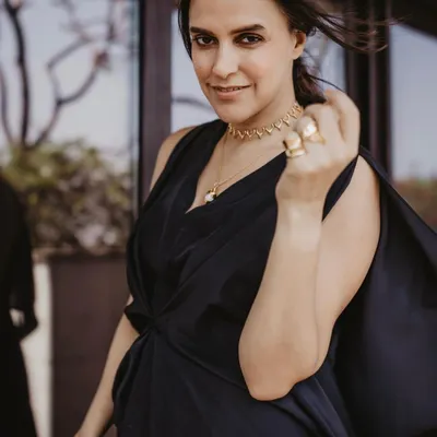 A candid shot of Neha Dhupia, showcasing the simple, textured ponytail I styled for her. It's a chic and modern look that is perfect for a public appearance.