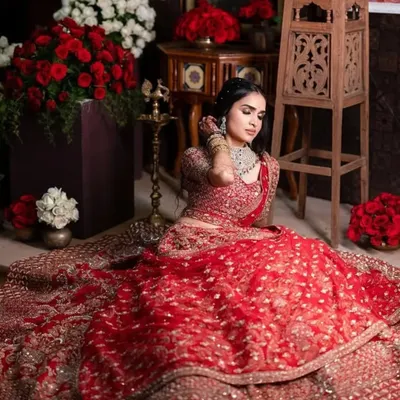 A regal reception look. This bride is wearing a magnificent red lehenga, and we paired it with a soft glam makeup look to keep it elegant and timeless.