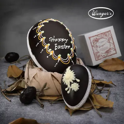 Our classic handmade Easter Egg, crafted from rich dark chocolate and intricately decorated with royal icing. It is the centerpiece of our Easter collection, a tradition loved by generations.