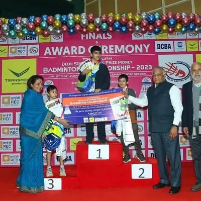 A moment of pure triumph for Arjun Singh Raghav at the Delhi State Badminton Championship 2023. Standing on the number one podium, he is celebrated for winning both the Boys Singles U-11 and Boys Doubles U-11 categories.