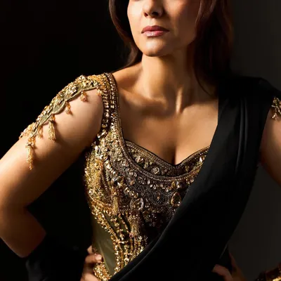 A close-up of the custom gold corset blouse created for Kajol's character in 'Maa'. The intricate detailing and shoulder adornments were designed to resemble armor, symbolizing her role as a protector. It's a piece that is part jewelry, part power statement.