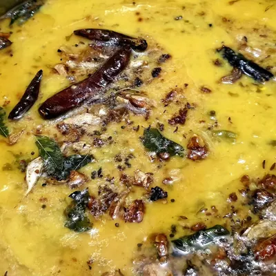 A close-up of our flavorful dal tadka, tempered with red chilies, curry leaves, and spices. A staple of our vegetarian catering menu.
