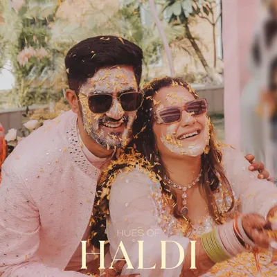 The calm before the beautiful storm of flowers and turmeric. This shot captures the couple's happy smiles and cool shades, ready for the Haldi fun to begin.