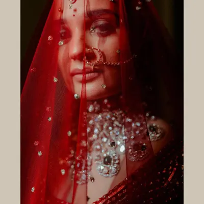 A moment of stillness behind the veil. I use light and shadow to create moody, artistic bridal portraits that are full of emotion and mystique. This shot focuses on the bride's eyes and the delicate details of her Falguni Shane Peacock ensemble.