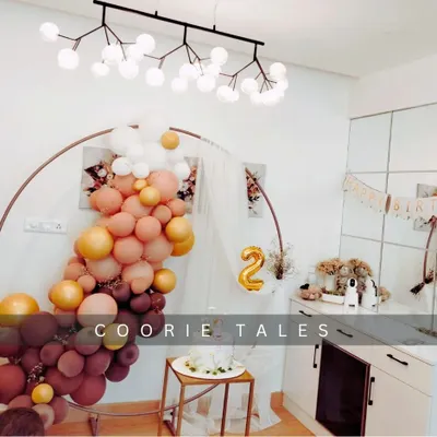 Celebrating a second birthday with a chic at-home setup. This design shows how we can transform any space with a stylish balloon arch in a warm, autumnal color palette and a modern circular backdrop.