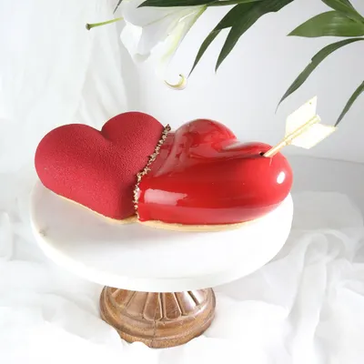 Cupid's masterpiece. This stunning heart-shaped entremet cake, with its glossy red glaze and velvet texture, is designed to make Valentine's Day unforgettable.