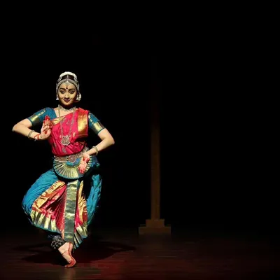 A graceful pose from the Kanasu Dance Event. The minimal lighting focuses all attention on the dancer's form and expression.