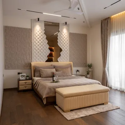 This master bedroom is a study in texture and tranquility. The unique 3D panel behind the bed creates a sculptural focal point, while the warm wooden floors and soft, neutral bedding invite rest. Every element is designed to soothe the senses and create a deeply personal sanctuary.