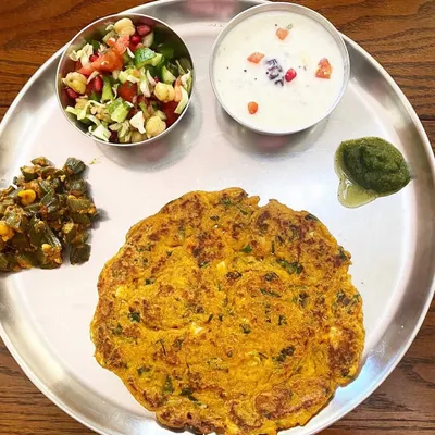 A simple, home-cooked meal is the cornerstone of good health. This plate features a methi paneer roti, okra with peanuts, a chickpea salad, and Greek yogurt. It's a perfect example of a balanced, nutrient-dense meal that I help my clients create.